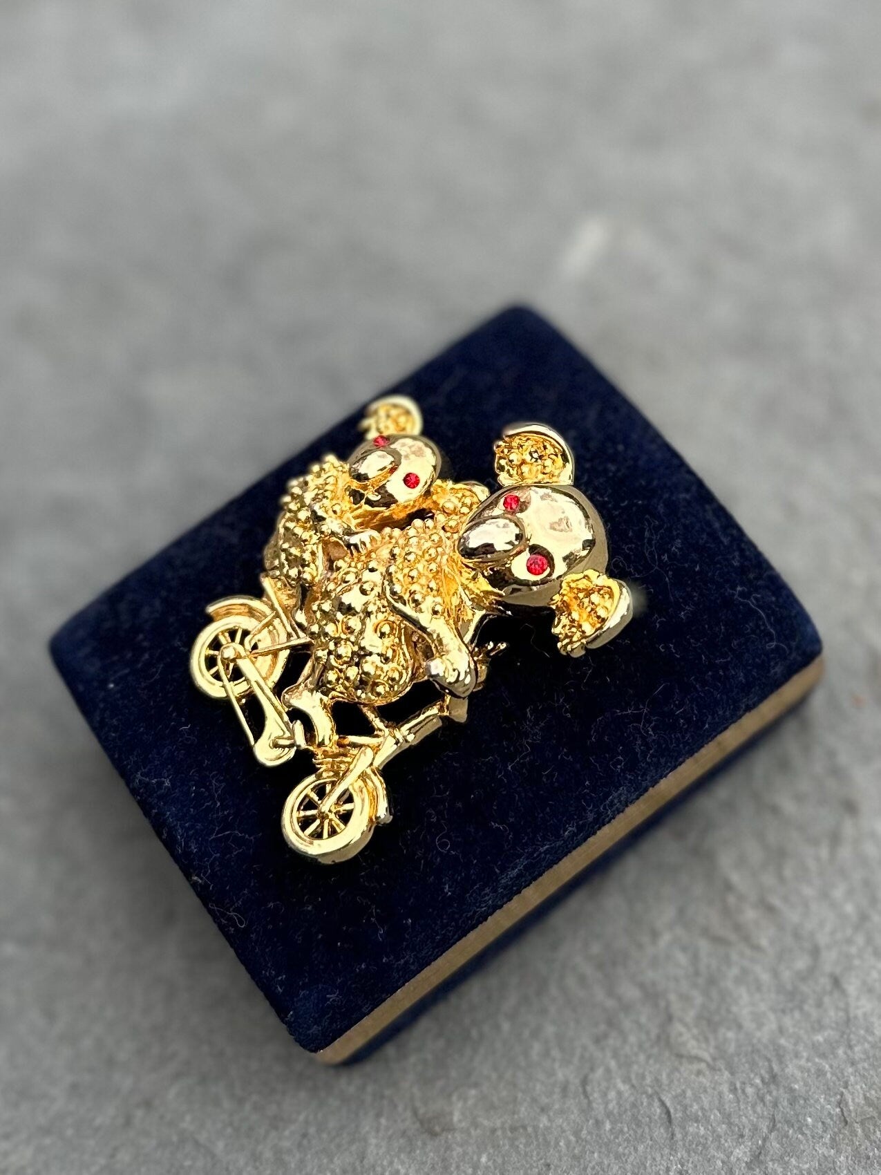 Vintage Gold Tone Koala Bear and Cub with Red Rhinestone Eyes Riding a Bike Brooch Pin
