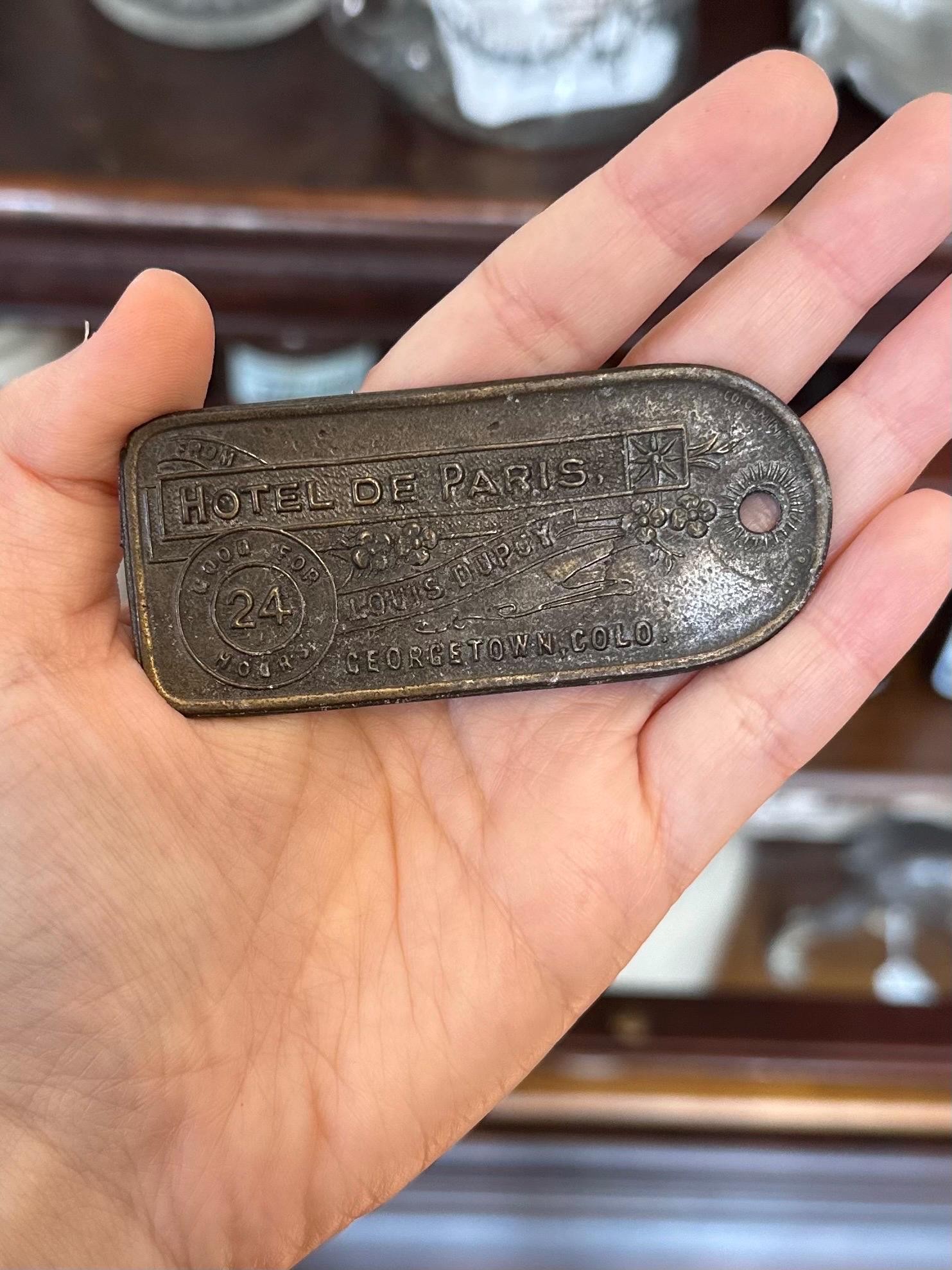 Vintage Reproduction Novelty Hotel de Paris Louis Dupuy Georgetown, Colo. Madame Sophie’s Brothel Metal Key Tag